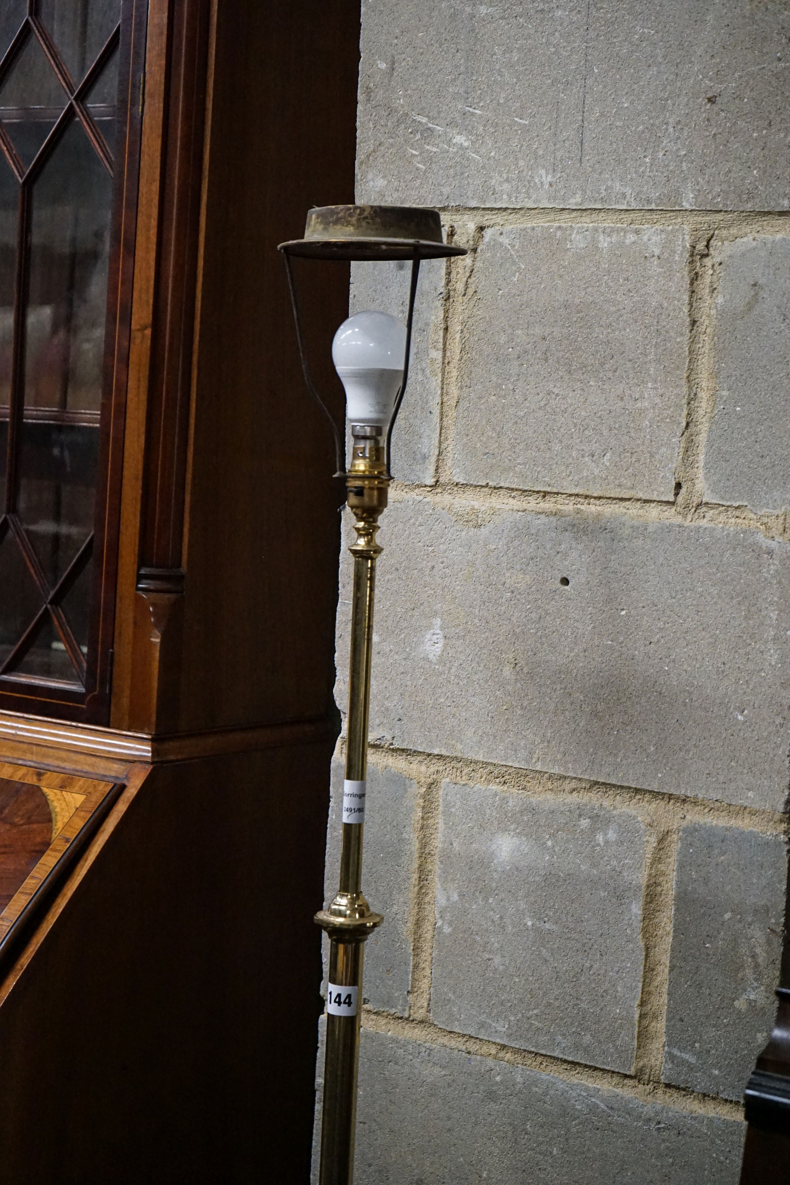 An Edwardian brass telescopic lamp standard, with Benson style foliate base, height 140cm